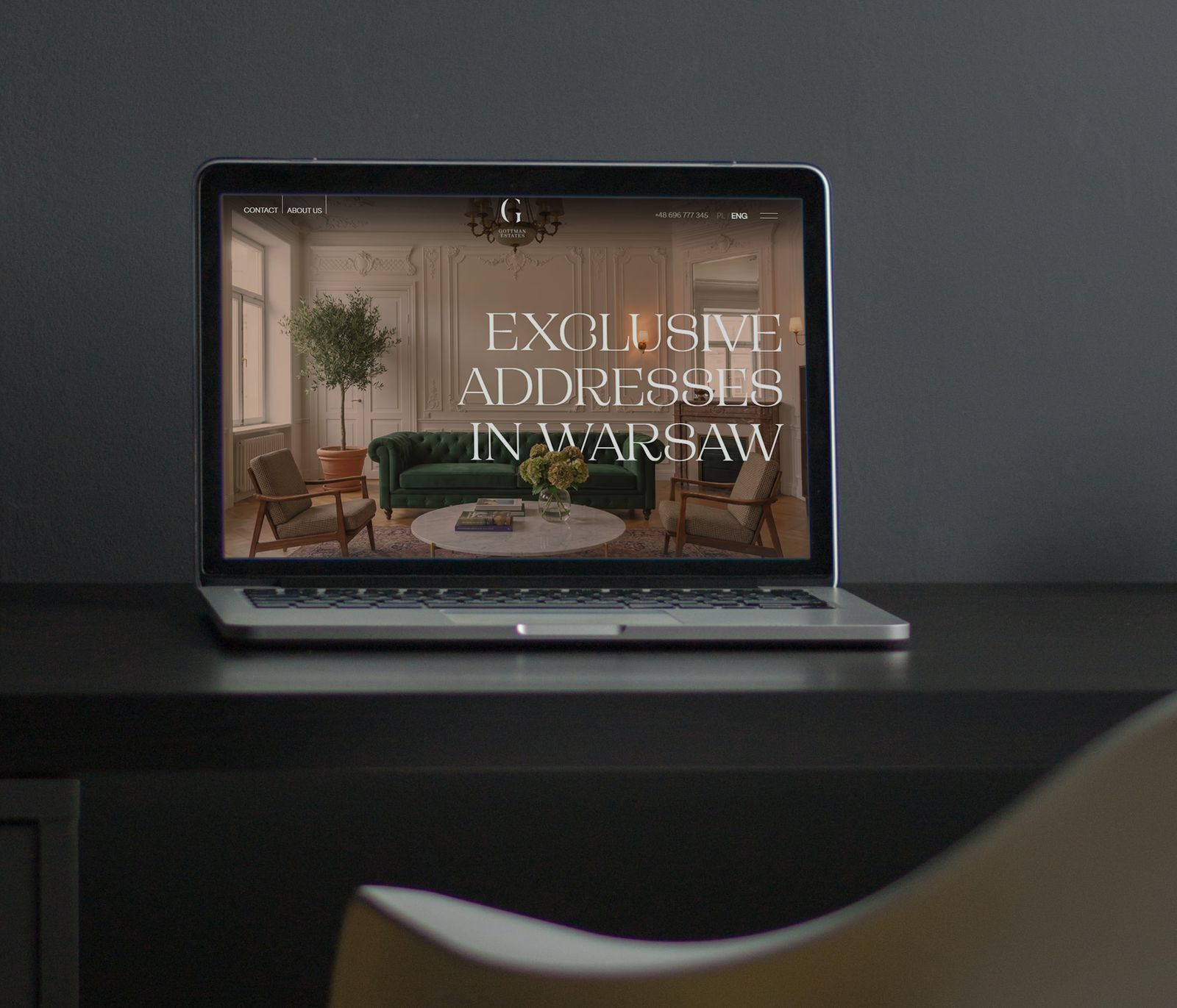 The Gottman Estates homepage on a laptop, reading “Exclusive addresses in Warsaw”